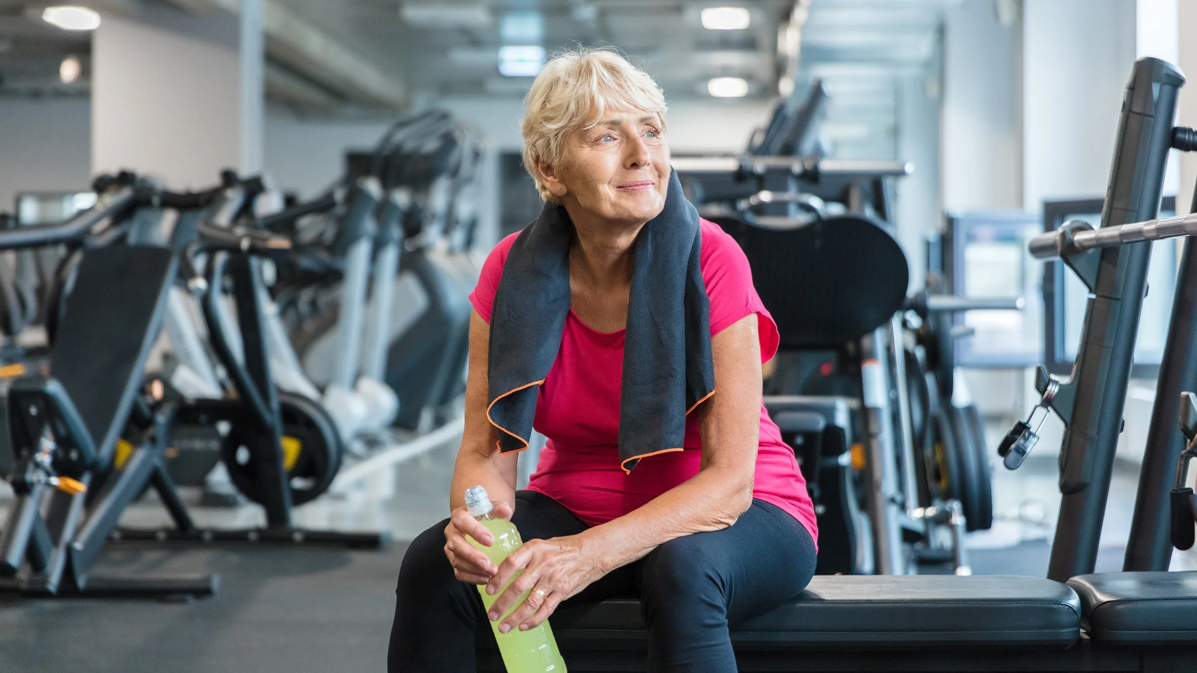 Woman hydrating with an electrolyte drink.