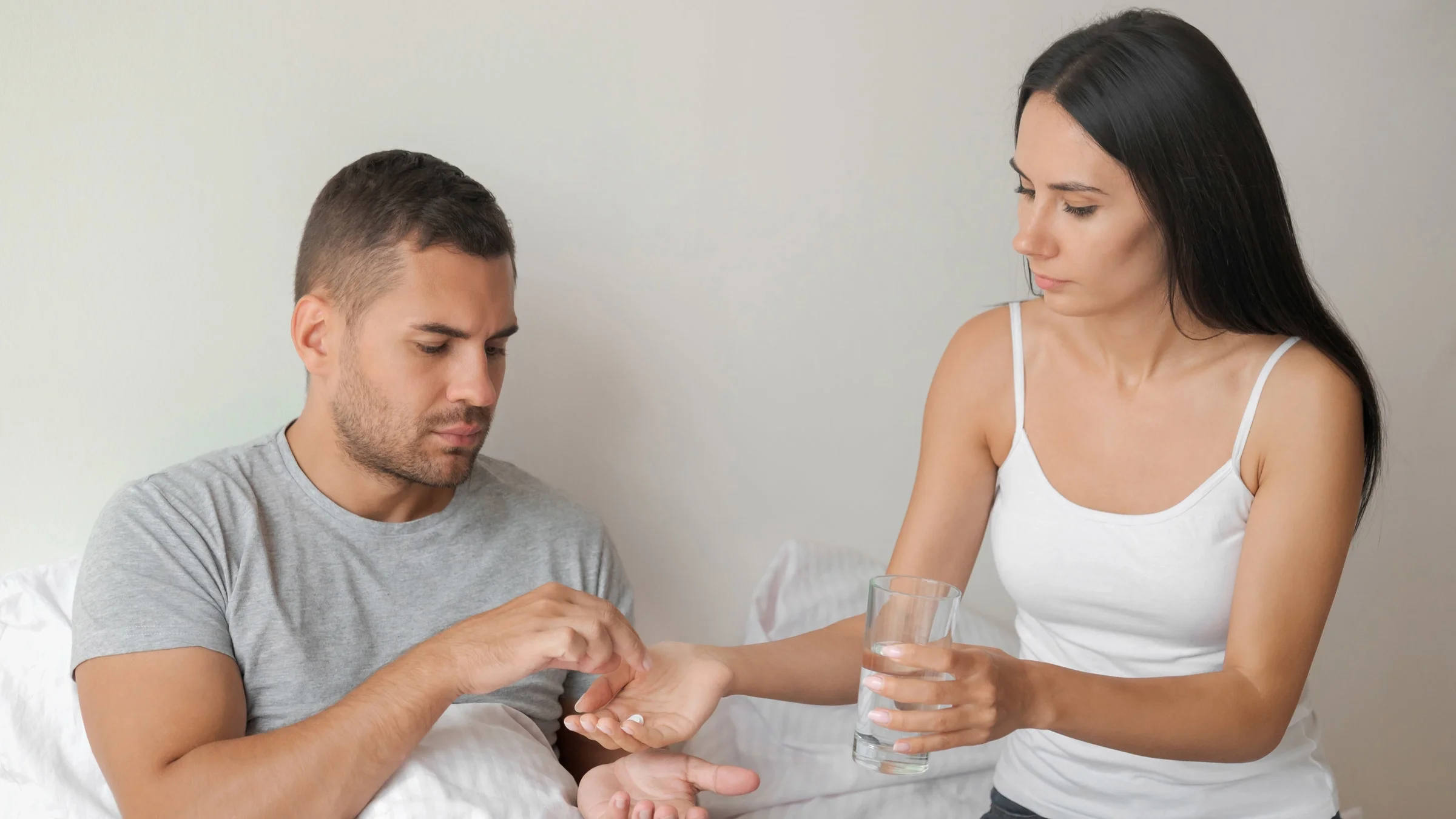 A couple taking pills together. 