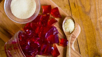diet-nutrition: gelatin powder and red jello on wooden surface1178158480