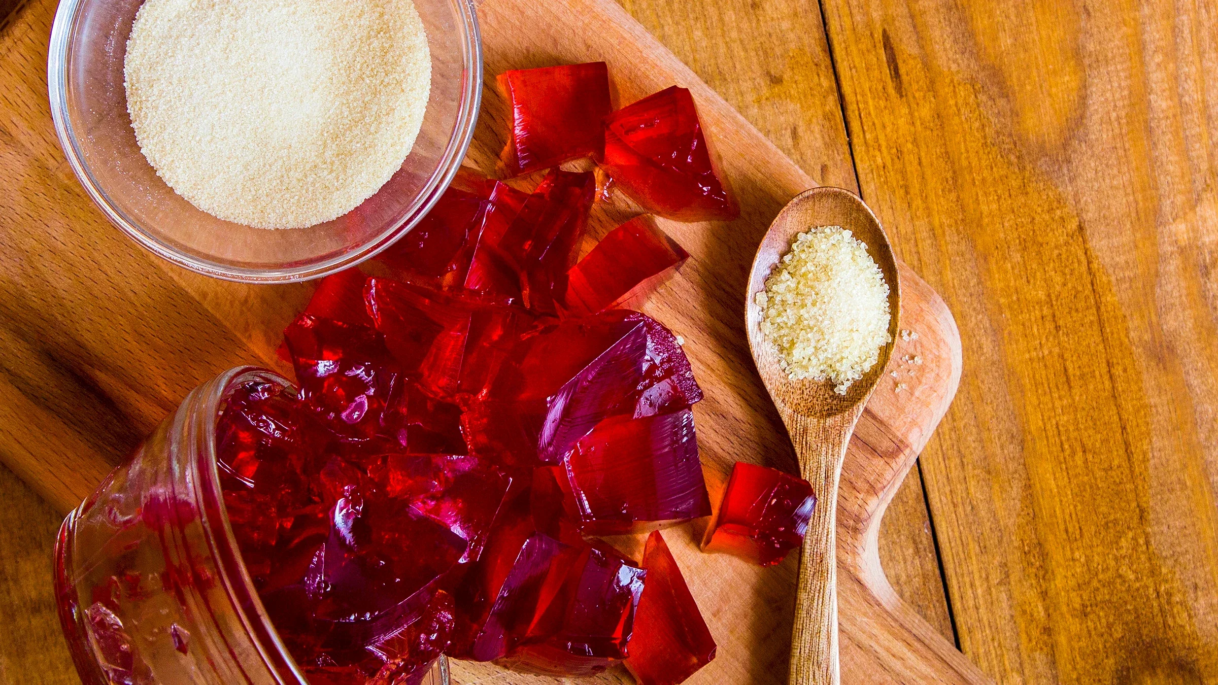 A spoonful of gelatin powder lies next to pieces of red gelatin dessert. 
EkaterinaZakharova/iStock via Getty Images Plus          