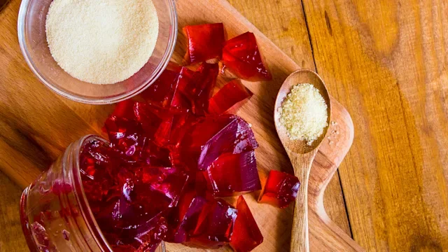 diet-nutrition: gelatin powder and red jello on wooden surface1178158480