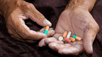 Health: Sildenafil: hand with various colorful pills-1073861764