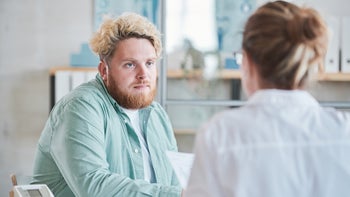 Liver Disease: young man serious conversation with doctor-1335814903