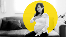 Black and white photo of a pregnant woman sitting on the couch with heartburn. She has her hand over her chest and is wincing in pain. There is an added yellow graphic circle behind her as well.
Antonio_Diaz/iStock via Getty Images
