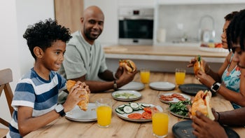 Xolair: child eating meal with family 2163220268