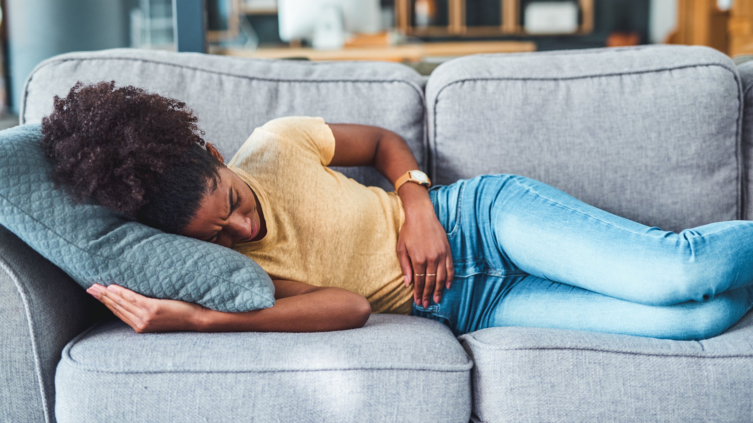 woman abdominal pain couch 1306632928
