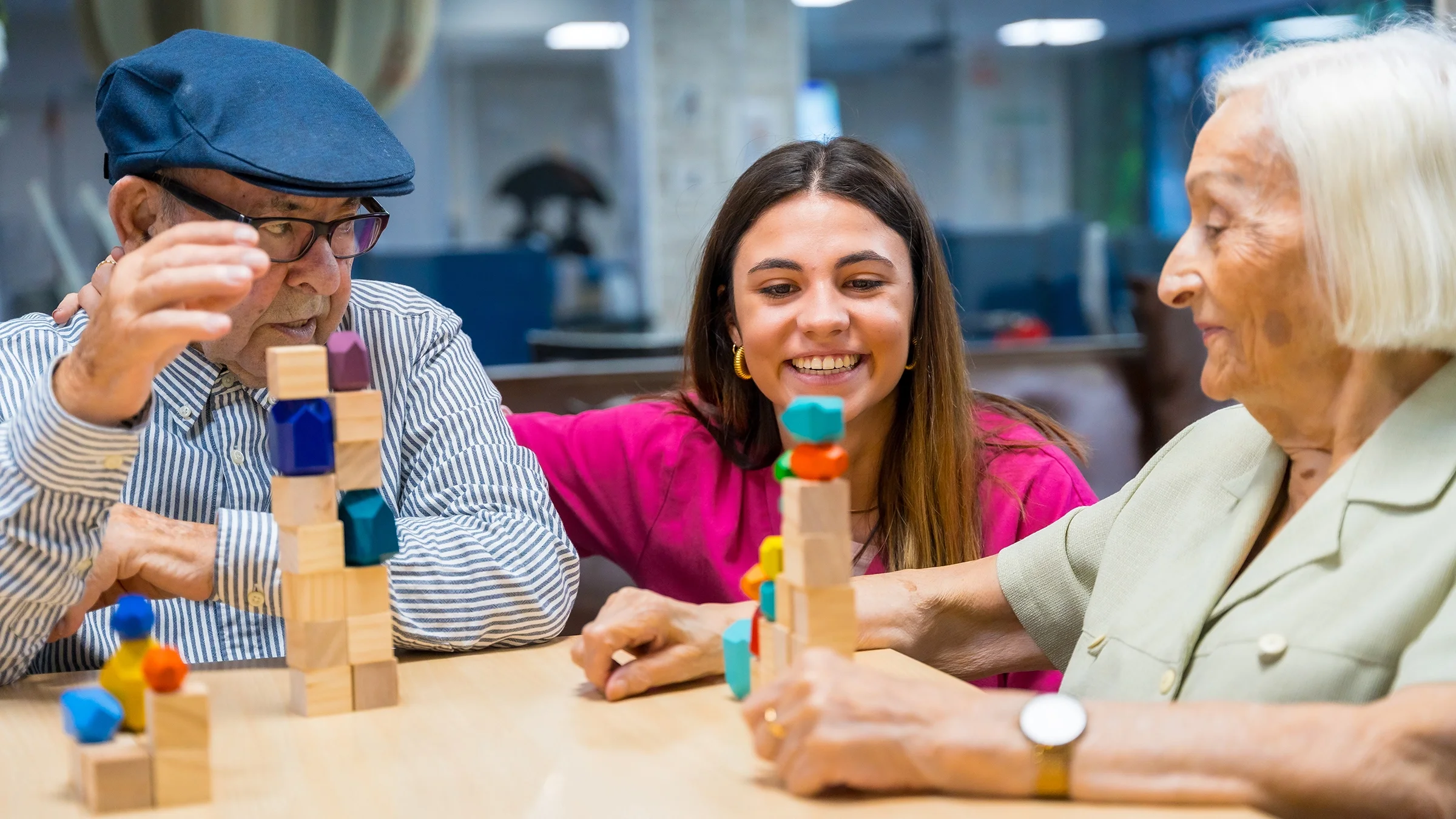 A nurse supervises seniors playing skill games in a nursing home.