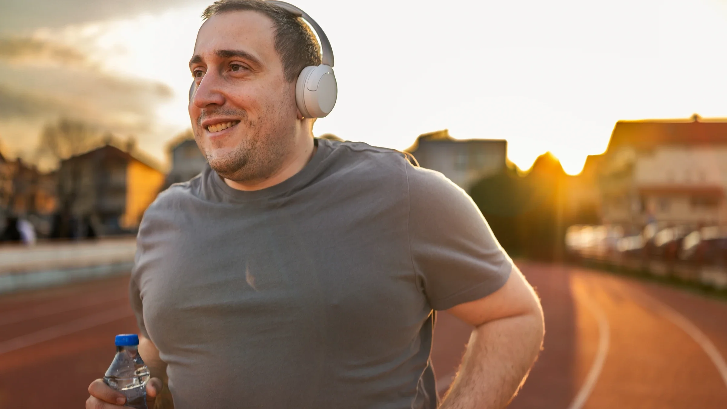 Man enjoying a run on track at sunset