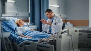 Gallstones: Galbladder removal: doctor explain something to woman in hospital bed-1321692342