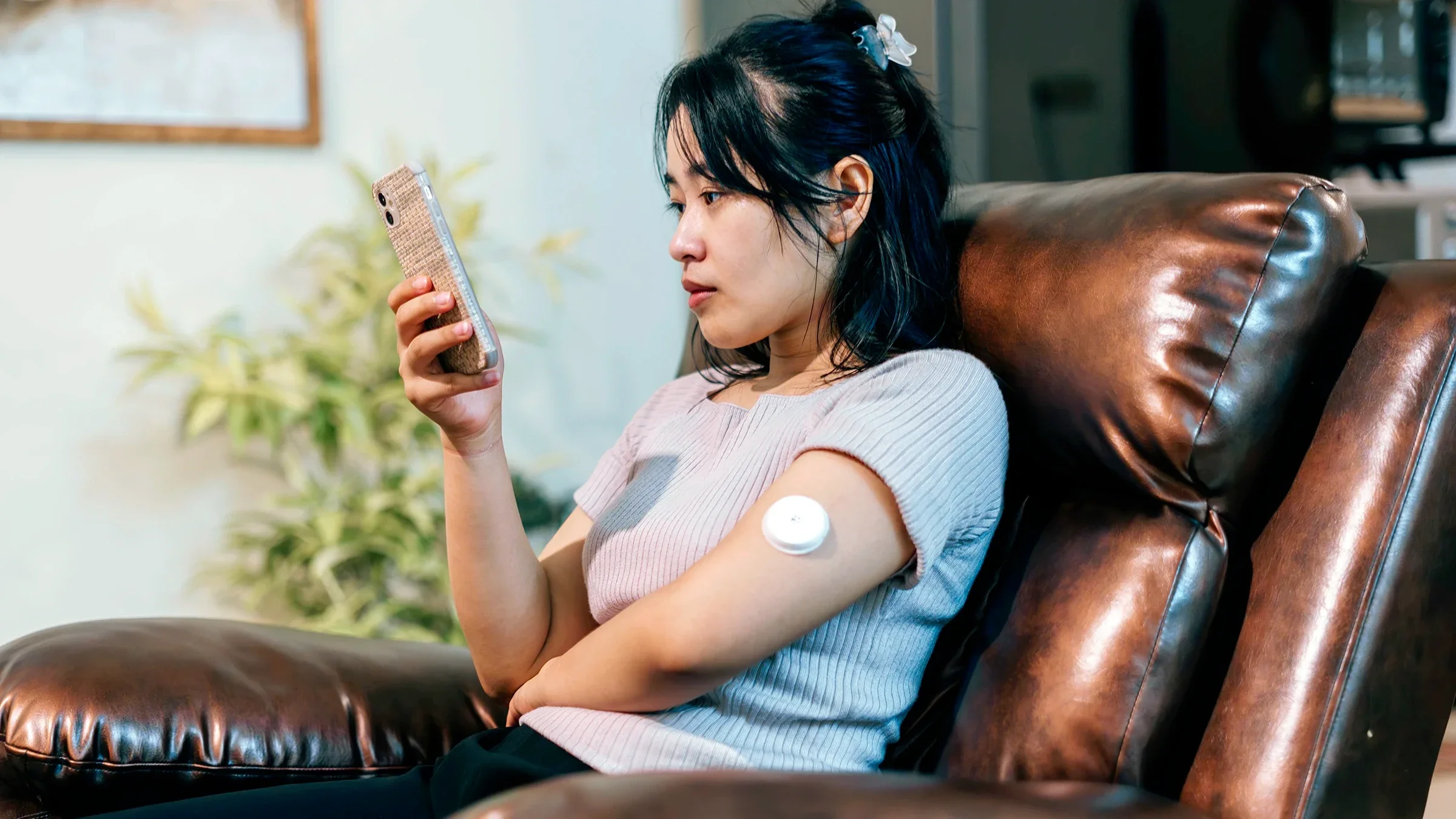 A woman wears a continuous glucose monitor on her arm.
rudi_suardi/E+ via Getty Images Plus