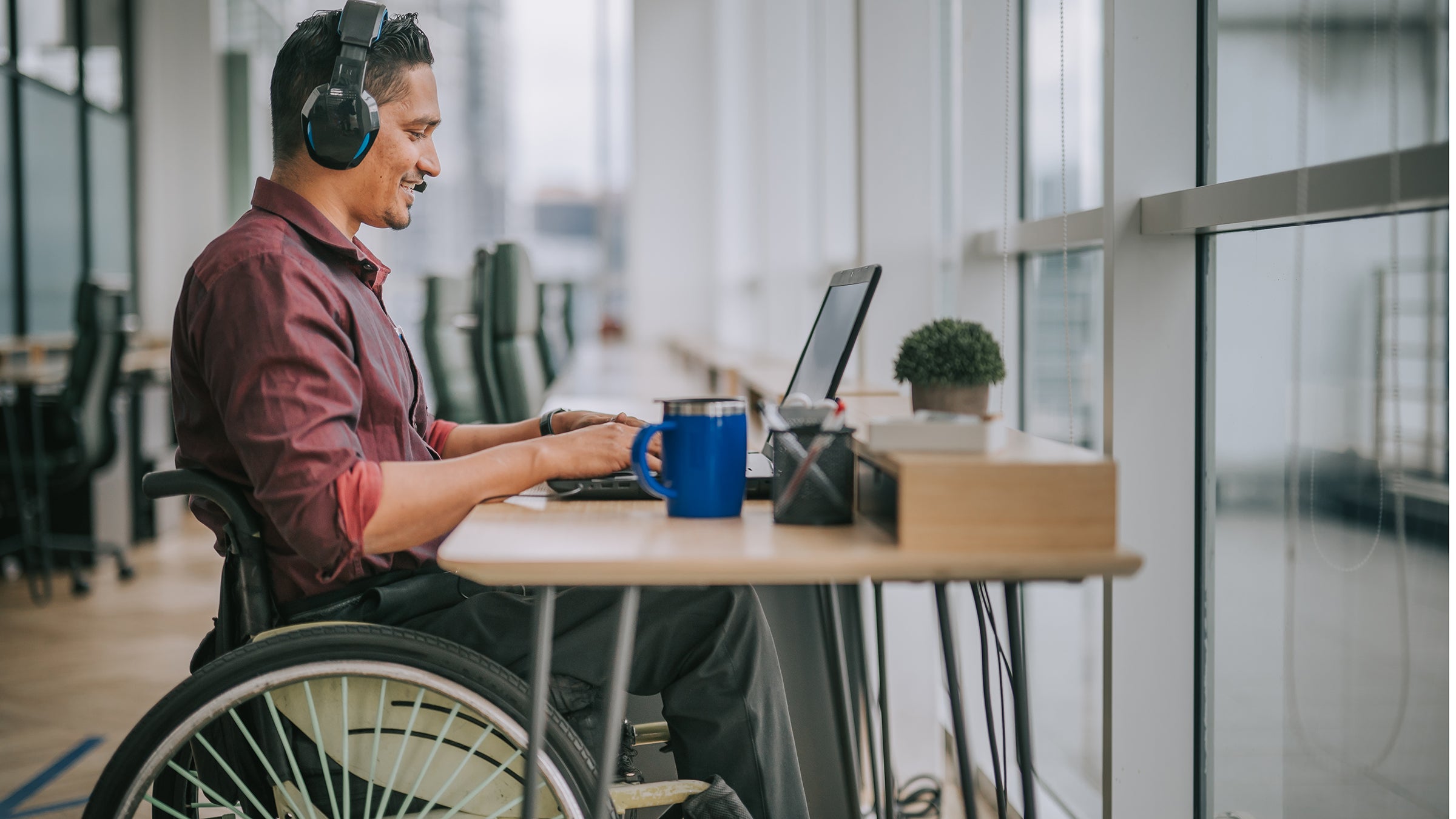 Health: Health insurance: man in wheelchair working at desk 1319810505
