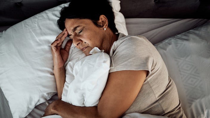 Woman lying in bed with insomnia.