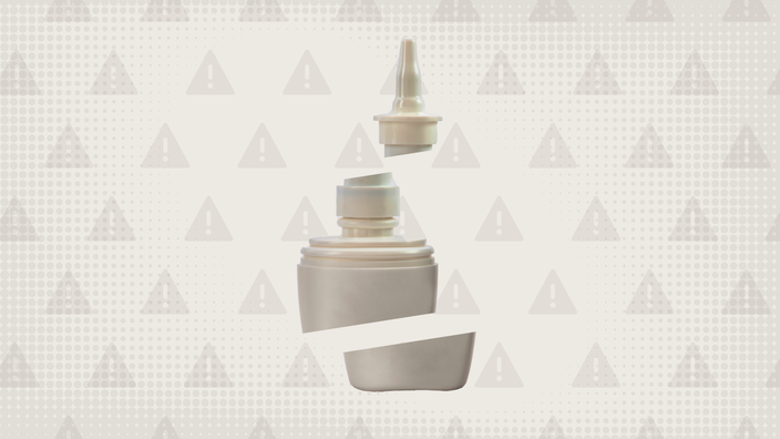 A nasal spray bottle cut into thirds is shown on a light gray background with a warning sign pattern.