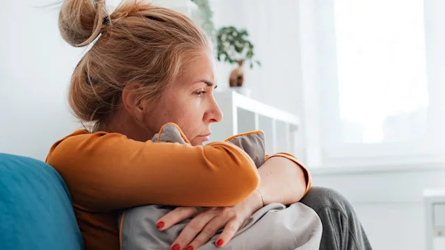 Health: Mental health: woman clutching a pillow 1413987763