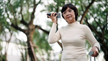 Senior Health: Ear: senior woman with smartphone to ear 2155621526