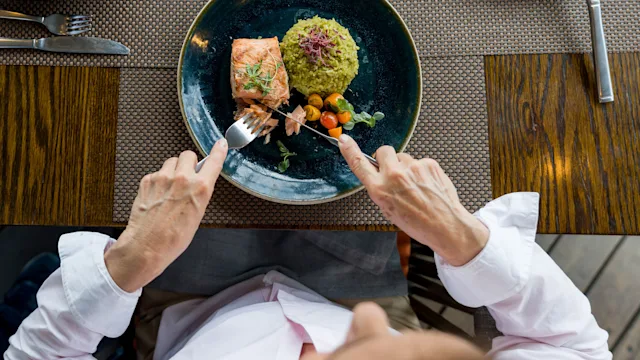Diet nutrition: overview woman cutting salmon 1346447978