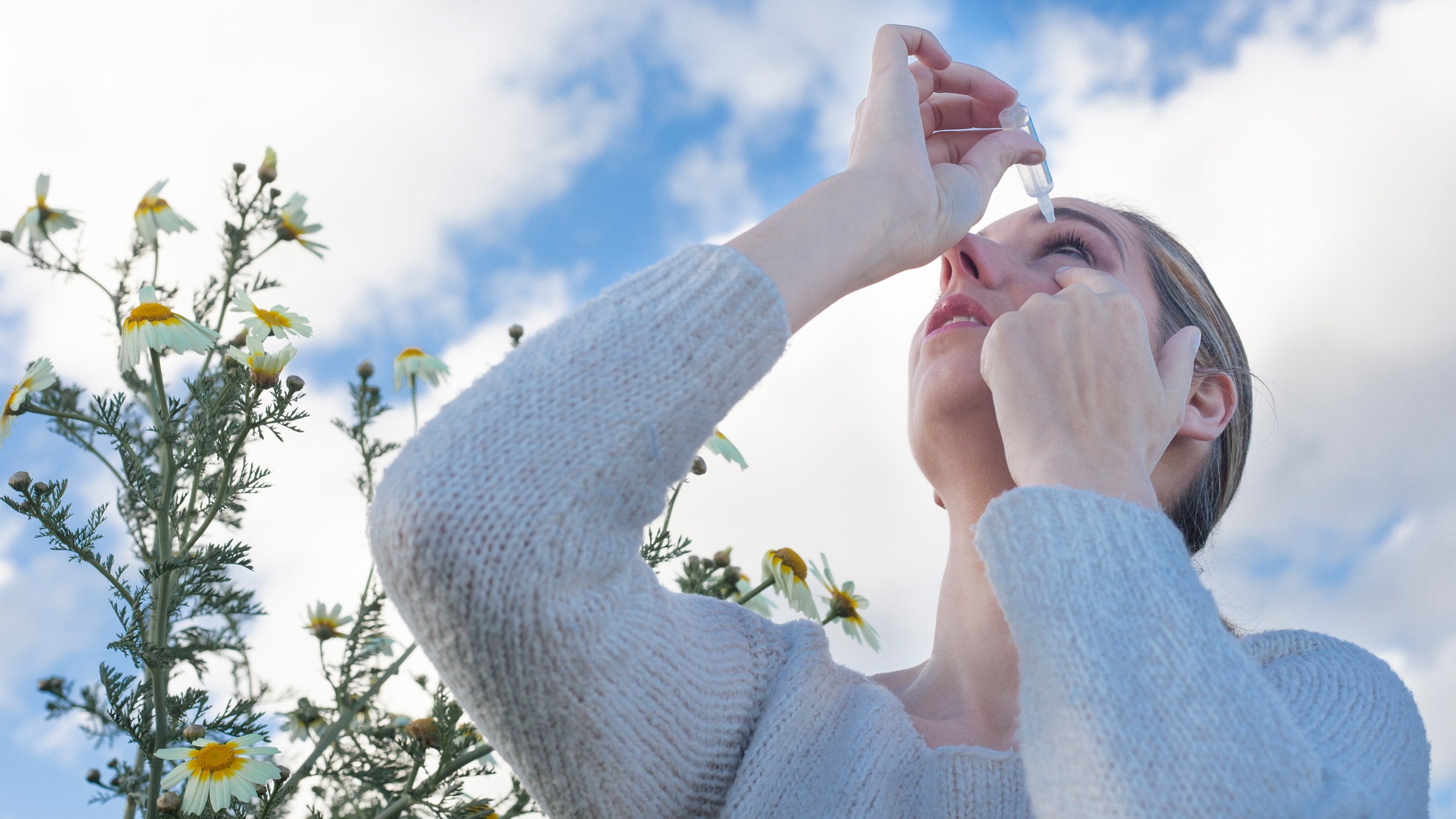 Allergies: Eye medicine: using eye drop in garden 520981334