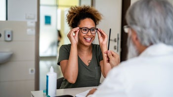 Health: FSA HSA: woman trying on new eyeglasses 1155980510