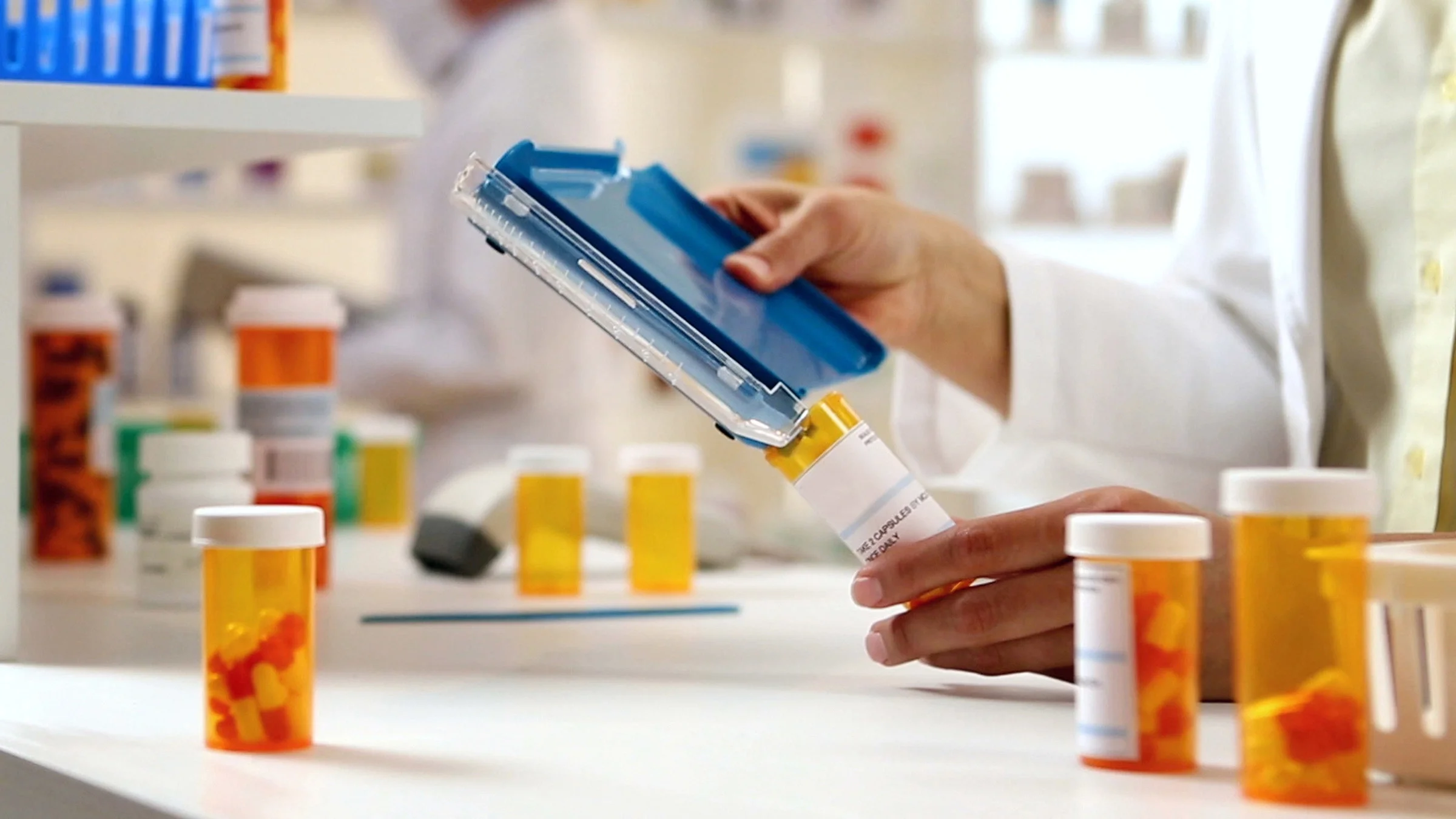 Close-up of a pharmacist filling a prescription.