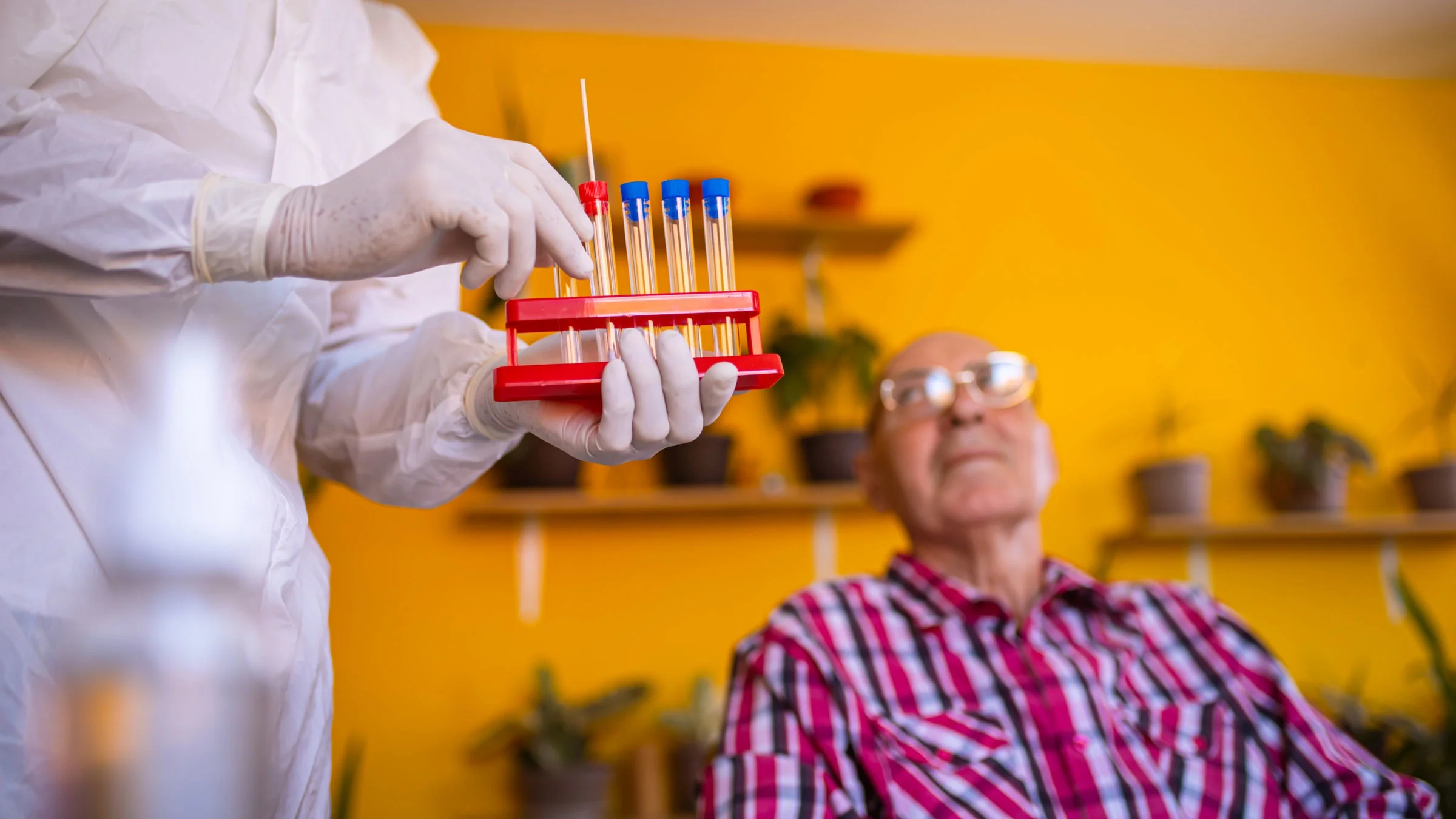 Senior man being tested for COVID with a PCR diagnostic kit.