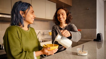 Diet nutrition: Calcium: parent pouring milk into childs cereal-1335801252