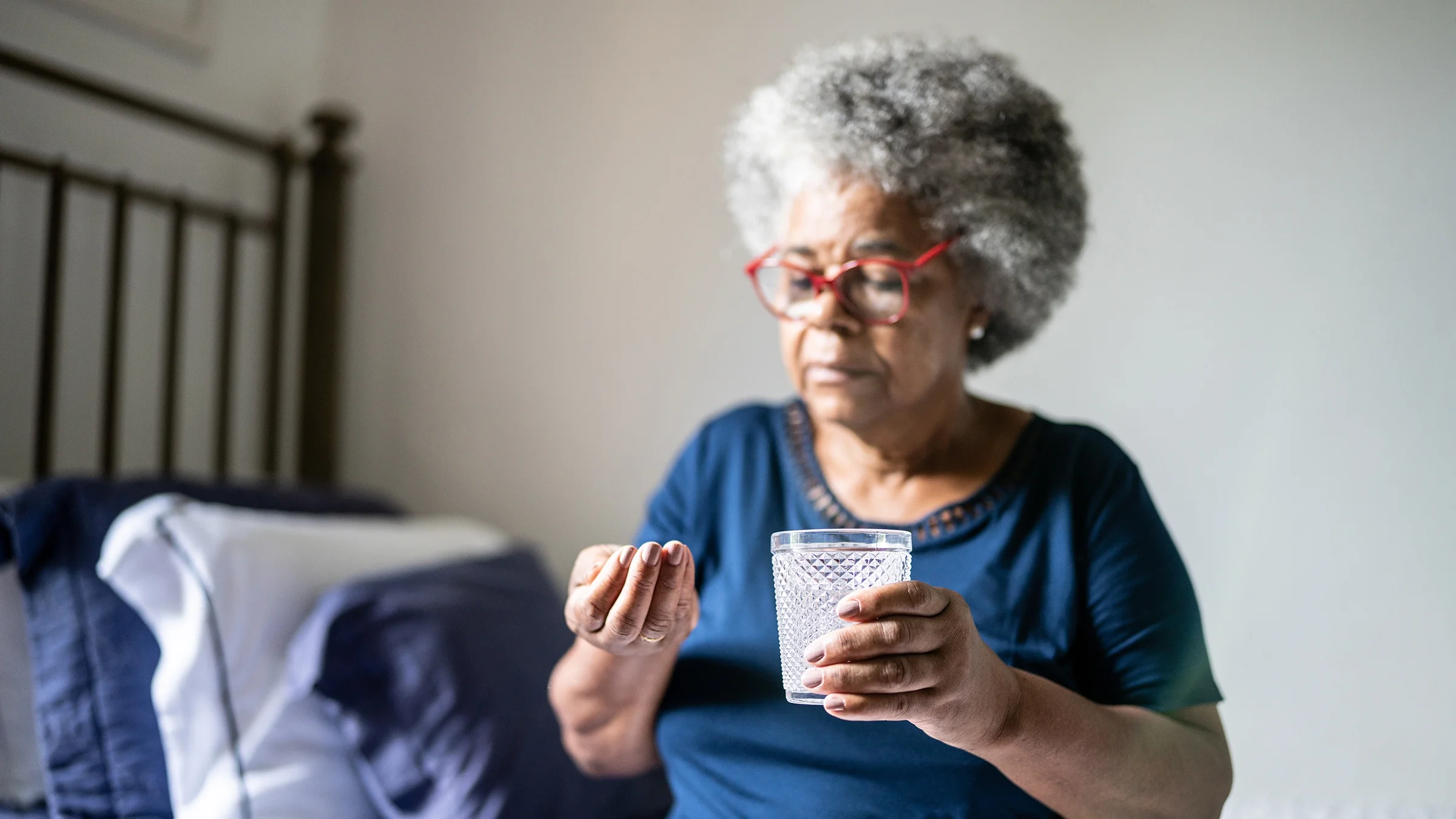 A woman prepares to take her medication.