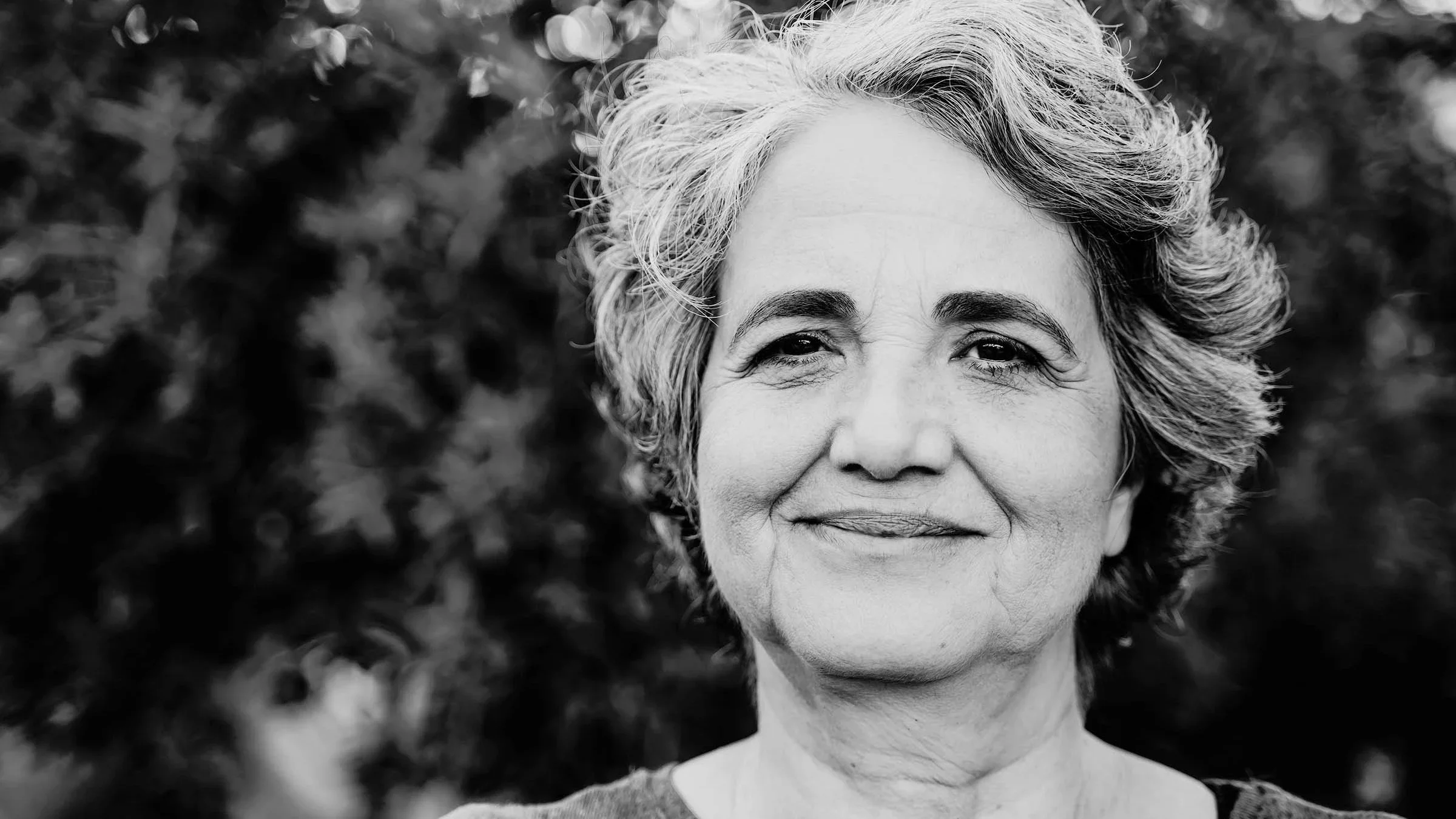 Black and white portrait of an older woman with gray hair.
