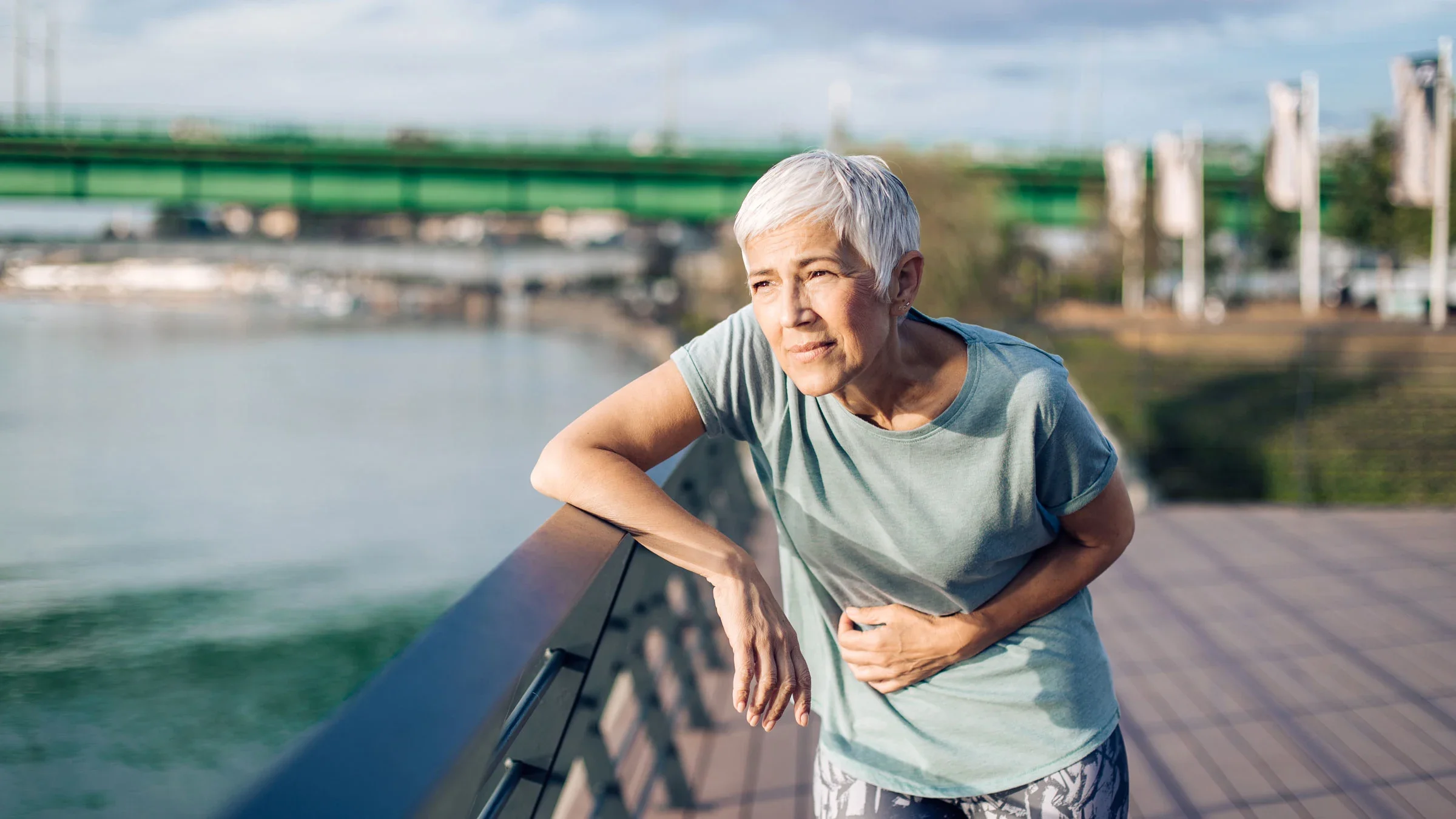 Older person having a stomachache while running outdoors.
MixMedia/E+ via Getty Images
