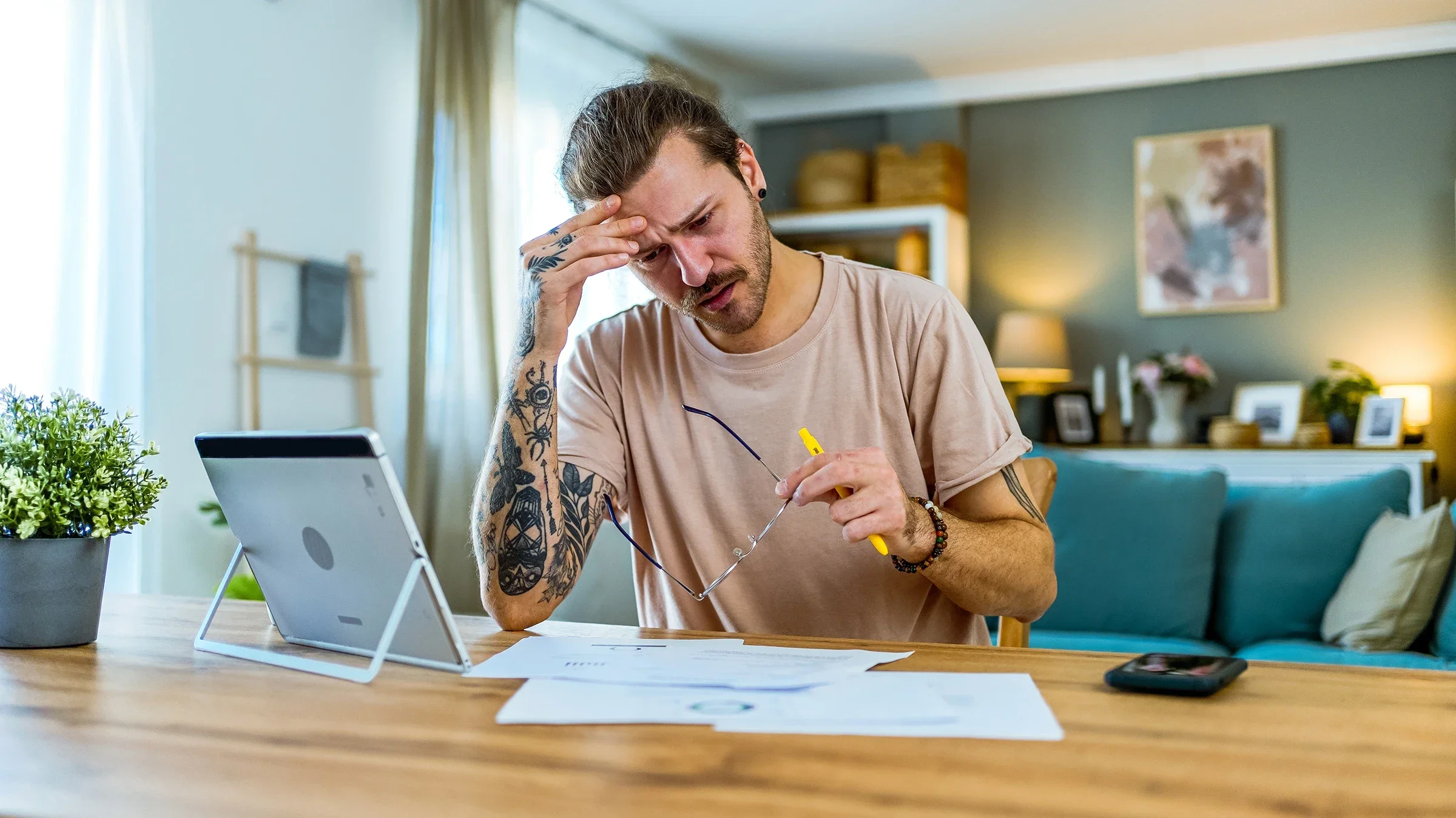 A man doing finances at home.
LordHenriVoton/E+ via Getty Images