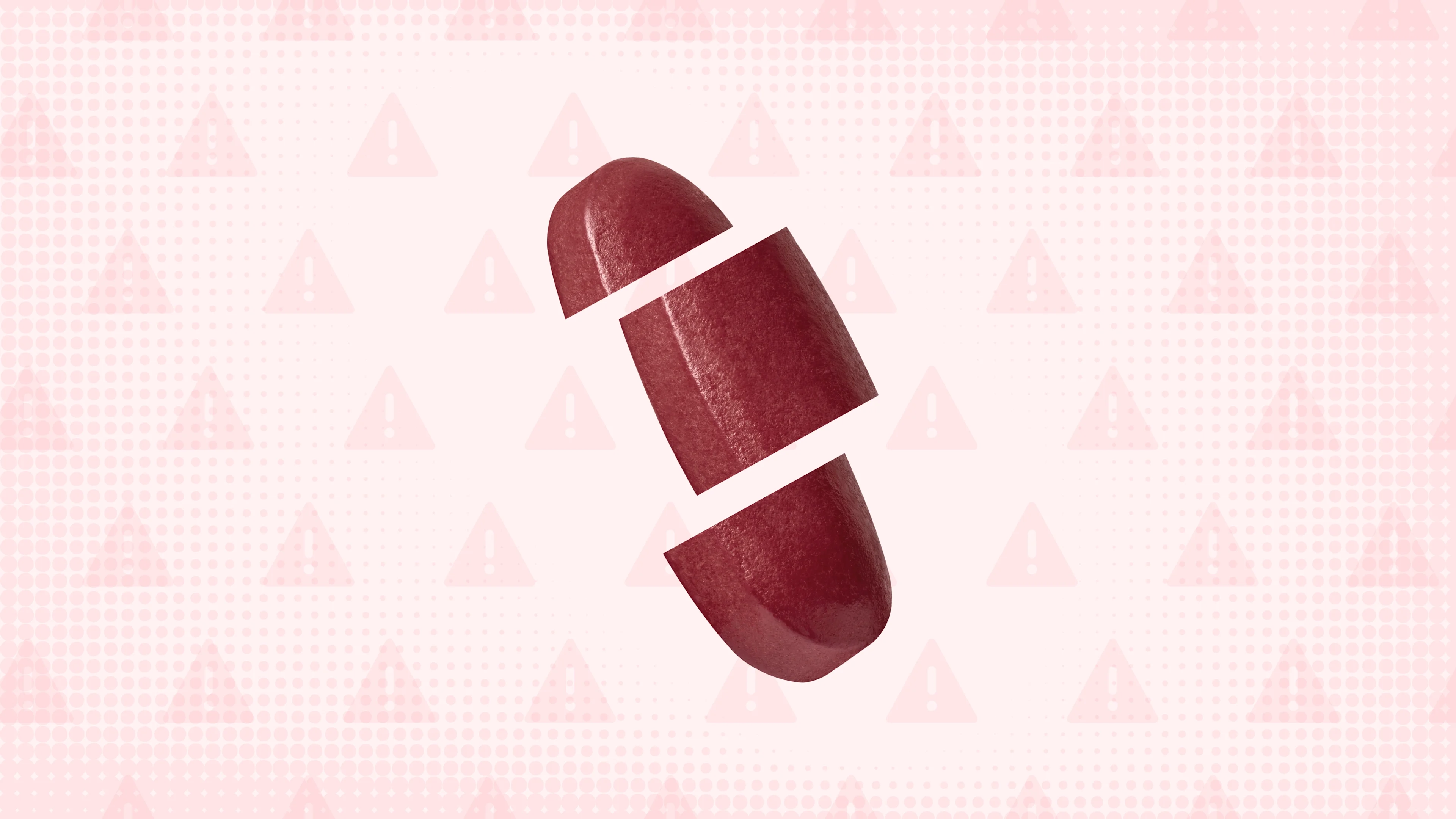 Light red background with texture and warning sign pattern. In the center is a red oblong pill cut into thirds.