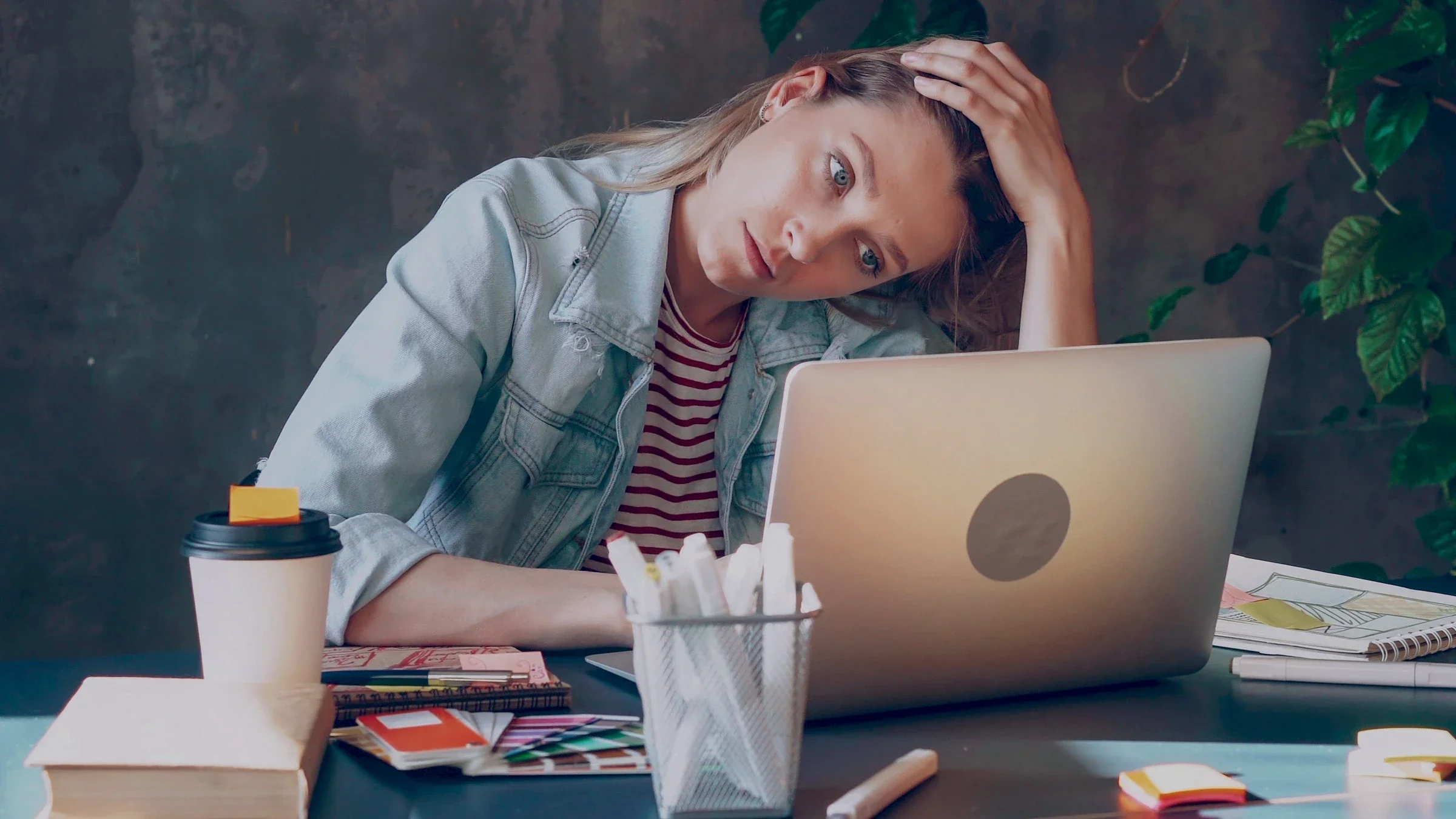 A person stressed out at their work desk.
silverkblack/iStock via Getty Images Plus 