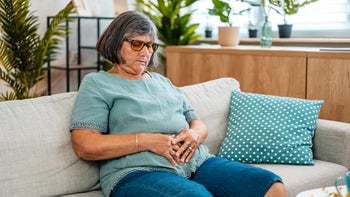 Omeprazole: woman with stomach ache 2167398099