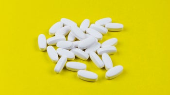Health: bactrim: pile of white pills yellow background-1317729535