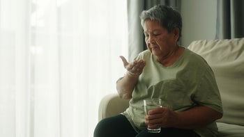 insomnia: woman taking a pill 2012489995