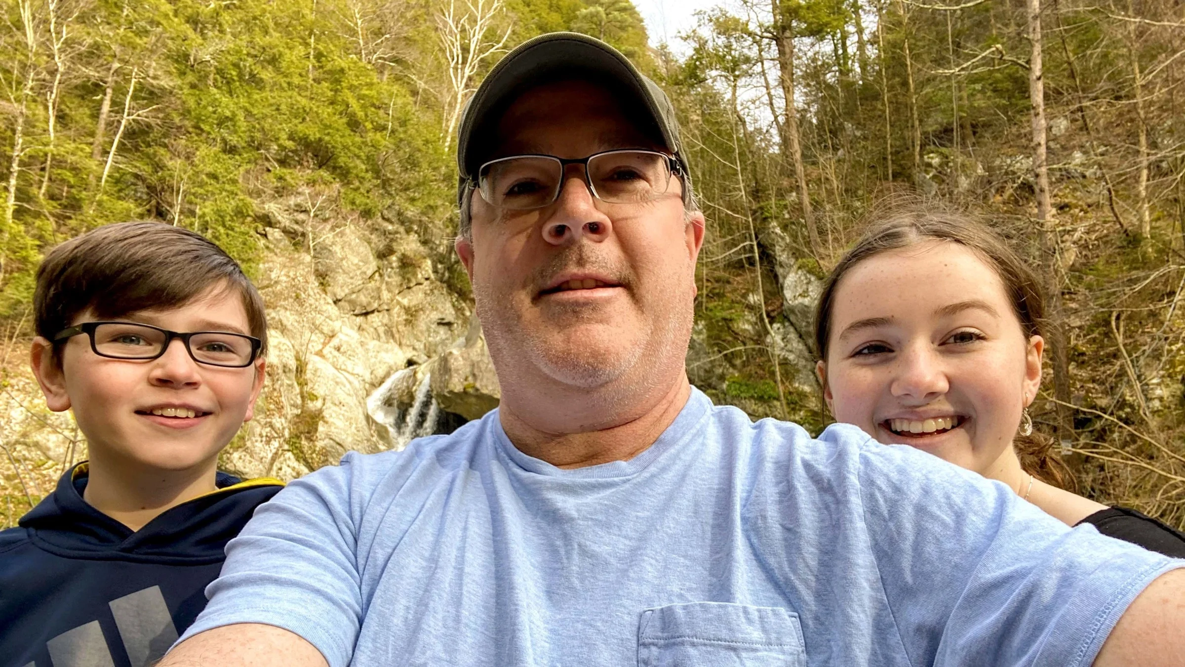 Man standing in middle of his two kids
