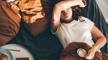 tired holding coffee breakfast in bed 1331753730