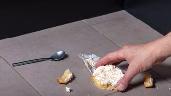 Diet Nutrition: closeup hand picking up food on floor 2169371247