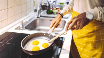 Procedures: closeup man cooking eggs 1735615247