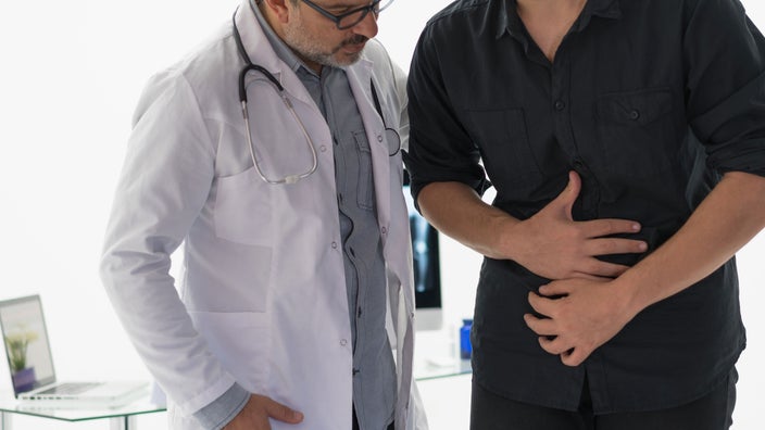 A healthcare professional examines a person’s abdomen. Some people may have exocrine pancreatic insufficiency. This happens when the pancreas doesn’t produce enough enzymes to turn food into nutrients that your body can absorb.