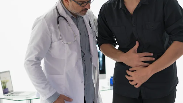 pancreatic insufficiency: doctor examines patient abdomen 1180669527