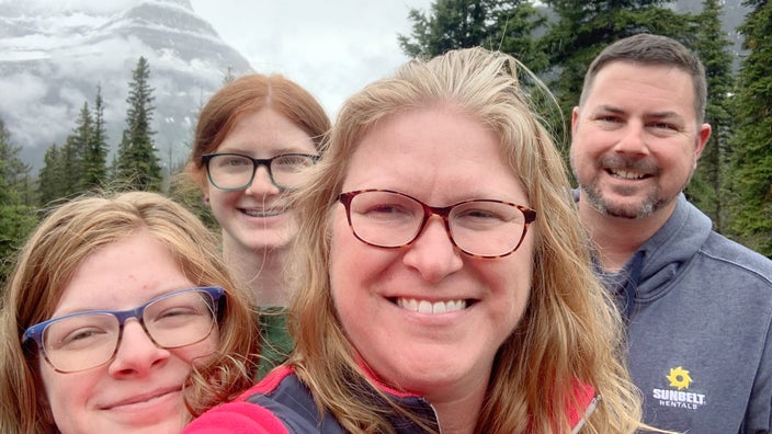 Emily Huff is pictured hiking with her husband and teenage daughters.