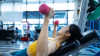 movement-exercise: woman doing incline dumbbell press 1443111634