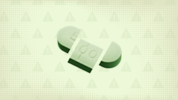 Light-green background with texture and warning sign pattern. In the center is a green pill cut into thirds.
GoodRx Health