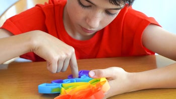 ADHD: child using fidget toy 2155432455