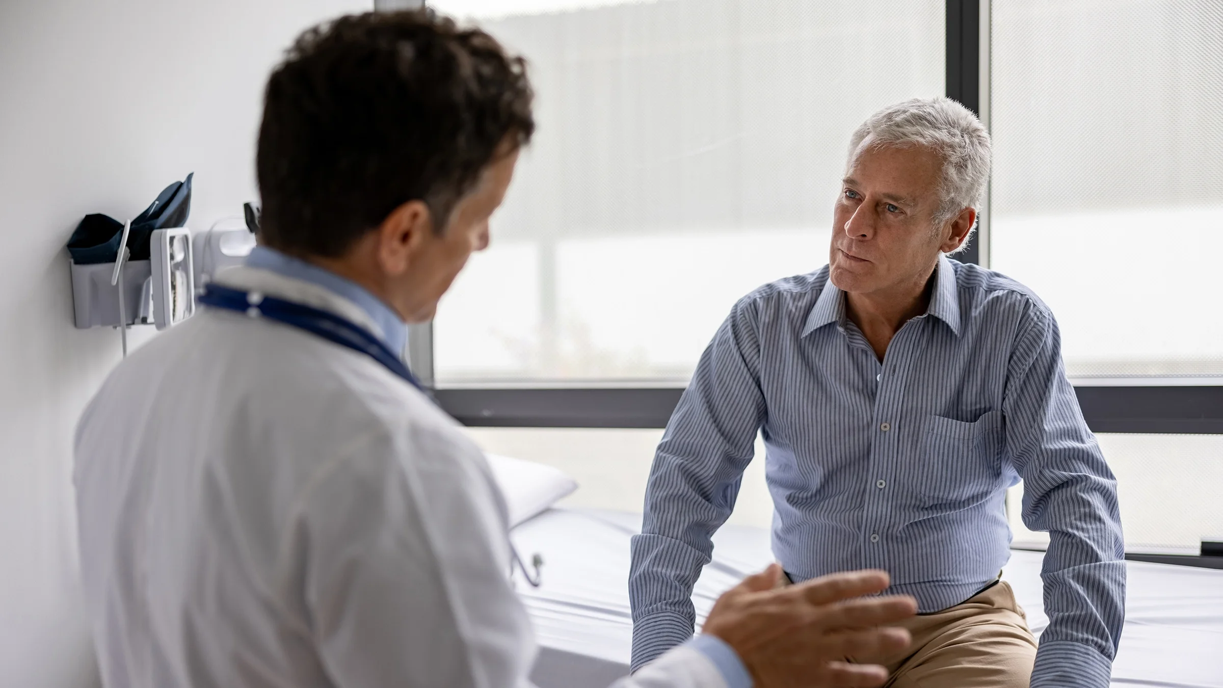 A senior man has a consultation with his doctor.