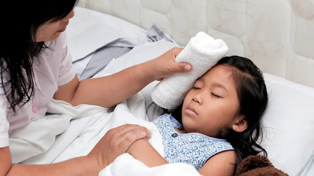Children's Health: mother caring for sick child at home 838082634