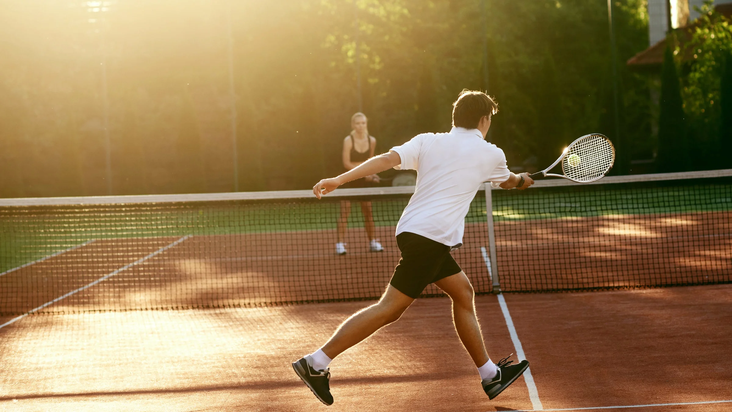 Two people playing tennis.