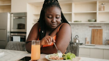 Movement-exercise: woman eating healthy meal at home 1761738438