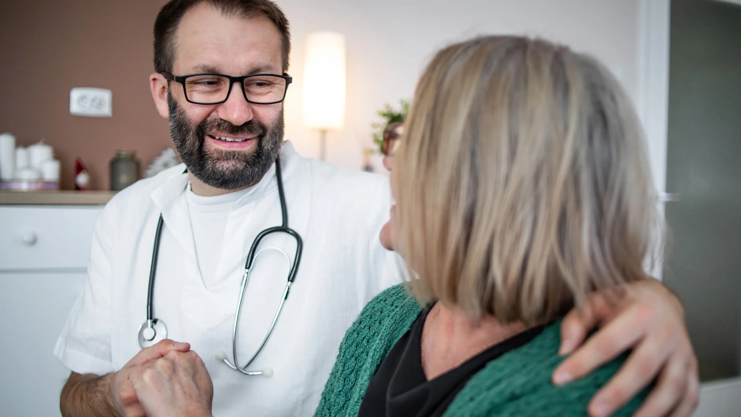 A doctor embracing their patient. 