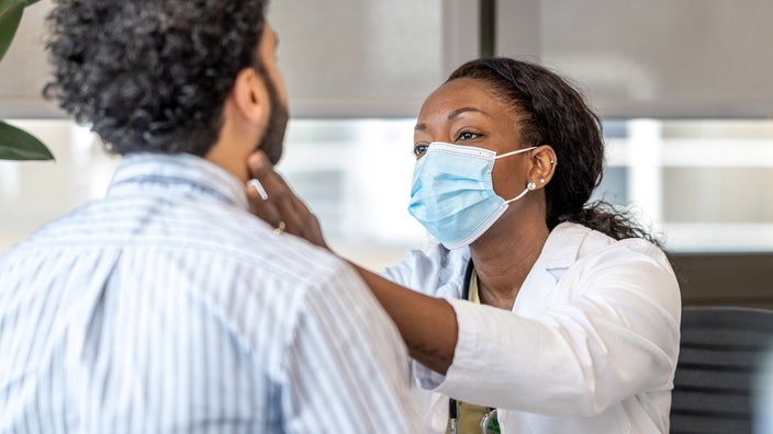 A doctor checking a patient's lymph nodes.
